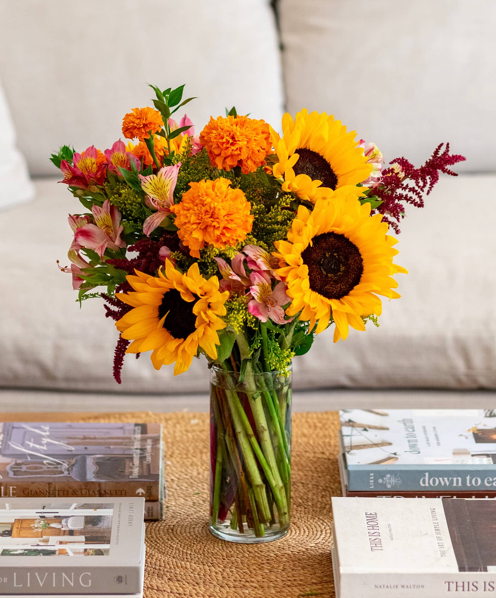 Vibrant sunflower bouquet mixed with marigolds and alstroemeria, perfect for brightening any space.