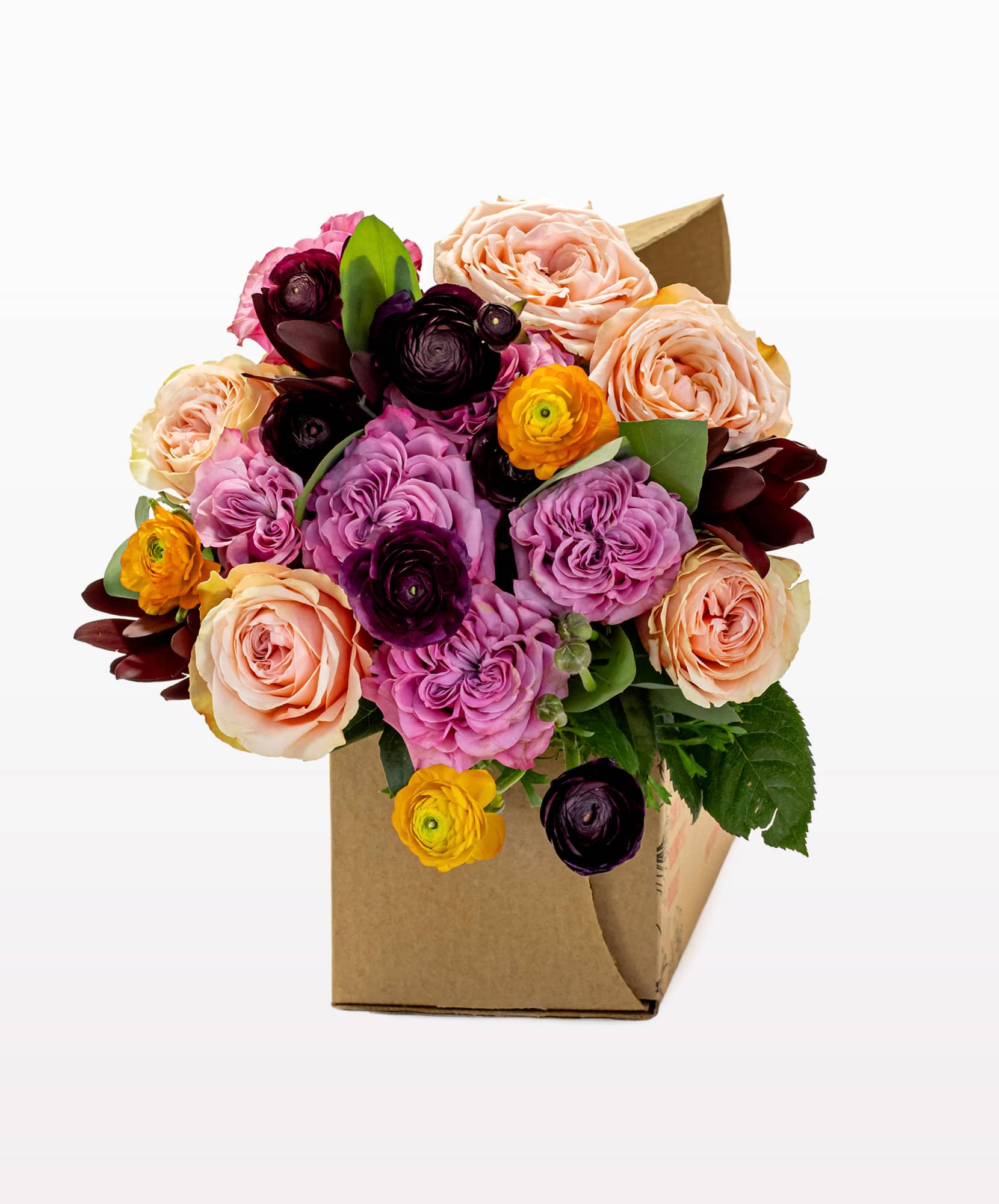 Vibrant mixed flower bouquet featuring pink roses, ranunculus, and lush greens in a box.